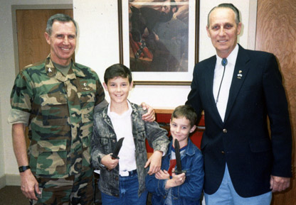 Recently passed CC Bob Powell (r) is pictured with (l-r) Col. John Ripley and Brock and Jonathan Oliver in this 1988 photo taken at Camp Lejeune.  It was a tough November for the Marine Corps:  John Ripley also died as well as former Commandant, Gen. Robert H. Barrow.