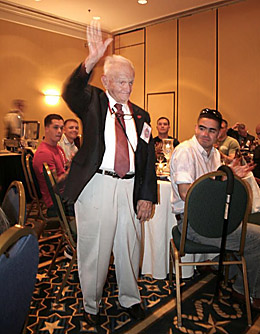Cy O'Brien waves to other combat correspondents during the conference in 2009.