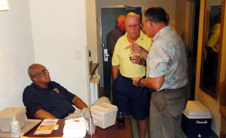 USMCCCA National President Don O'Neal (seated) flew in from San Antonio for the tournament. Here he listens as Dick Hrebik © and Joe Judge discuss Hrebik's new book "The Warrior Among Us" at a pre-tournament happy hour hosted by Tournament Chair Red Carpenter (partially seen in background).
