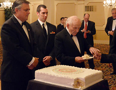 Don Knight gets first piece of cake as the oldest Marine on hand.