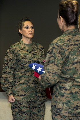 Colonel Annita Best, left, assistant deputy public affairs, Marine Corps Installations East, stands at the position of attention during her retirement ceremony, Camp Lejeune, N.C., Dec. 30, 2016. Best retired after 30 years of honorable and faithful service. (U.S. Marine Corps photo by Cpl Judith L. Harte)