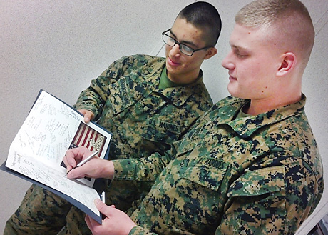 fcs. Devon K. Tindle of Milford, Neb. and Issac Ibarra of Naples, Fla. were among the warriors who signed a custom get well card for Marine Public Affairs legend at DINFOS earlier this month.  Both  Marines are enrolled as  Basic Public Affairs Specialist Course students. (Photos by Staff Sgt Justin J. Shemanski and Brian Tuthill)