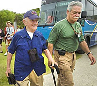 Return journey: World War II veteran Cyril O'Brien, left, arrives at Jeff's Pirate's Cove with Bob Perry of Military Historical Tours on March 16, 2009. Liberators including O'Brien and others stopped on Guam on their way to Iwo Jima for a World War II commemoration. (Pacific Daily News file photo)