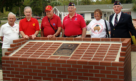 Members of the Central Florida Chapter of the 1st Marine Division Association in front of the memorial.
