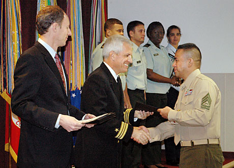 CC member Gunnery Sgt. Joe Espinosa completed DINFOS Instructor Training Course Dec. 15.  He is being congratulated by graduation guest speaker, mustang Lt. Cmdr. Bruce Colkitt.  The Guns serves as NCOIC for the Public Affairs Leadership Department where he has the daily challenge of dealing with the likes of John Dodd, Scott Woosley, Glenn and Laura Holloway, John Hoellwarth, Keith Oliver, Bob Jordan and USMCCCA affiliate member Dave Phillips.  (Photo by Lt. Col. Frank Urben, USAF ret.)