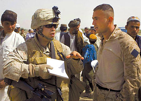 Staff Sgt. Luis Agostini interviews a Marine after a patrol.