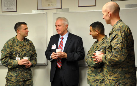Dr. Michael McClung visits with Marine Corps public affairs officers, (left to right) Capt. Gregory Wolf, Maj. Al Eskalis and Capt. Eric Flanagan, in the Maj. Megan McClung Conference Room located in the Headquarters Marine Corps Division of Public Affairs Office at the Pentagon. The conference room was dedicated to Maj. McClung after her Humvee struck a massive improvised explosive device, instantly killing her and two U.S. Army soldiers in Iraq, Dec. 6, 2006. McClung served as the public affairs officer for the Army's 1st Brigade, 1st Armored Division. Michael and his wife, Dr. Re McClung, have been devoted to carry on their daughter's legacy, which revolved around the three things she lived by: mind, body and spirit. (File Photo)