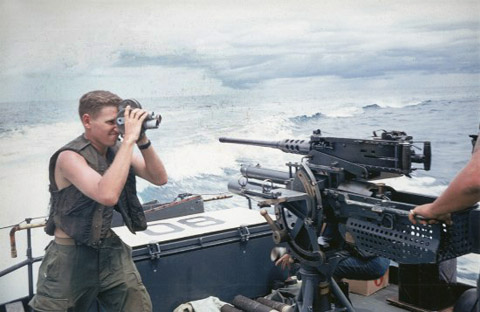 Corporal William T. Perkins Jr., filming U.S. Navy sailors aboard a Patrol Fast Craft, or 