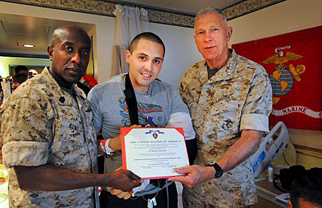 Sgt. Maj. Carlton W. Kent, Cpl. Eugenio Montanez, Gen. James T. Conway recieving the Purple Heart.