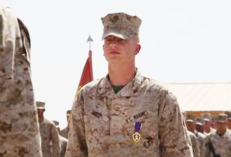 Lance Cpl. Joshua M. Rudy, a combat videographer with Regimental Combat Team 6, stands at attention during an award ceremony on Camp Delaram II, Nimroz province, Afghanistan May 23, 2012. Rudy was awarded the Purple Heart for wounds received in action. LCpl Rudy received a head wound after a grenade attack while conducting combat operations in the area of Shukvani, Helmand province, Afghanistan March 29, 2012.(USMC photo by Staff Sgt. Raul Gonzalez)