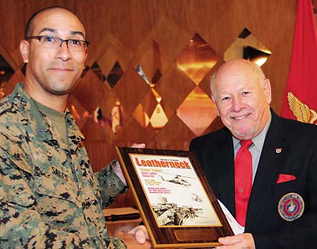 Marine Sergeant Shawn Sales, a Visual Communications Instructor at the Department of Defense Information School, Ft. Meade, Md., and reigning Military Illustrator of the Year, was honored by Leatherneck magazine for his September issue cover art. Making the presentation was retired Marine Major Bob Jordan, a former Leatherneck staffer and current DINFOS faculty member. Sales and Jordan were participants in a luncheon meeting of the USMC Combat Correspondents Association's Maryland Chapter, held at Club Meade on Nov. 16. (Photo by Rick Corral)