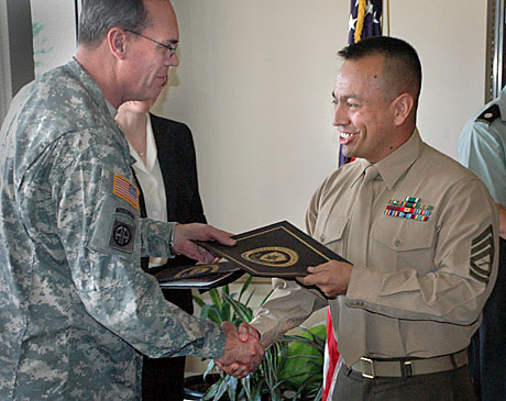 CC, GySgt. Sergio Jimenez, is congratulated by DINFOS Commandant, Army Col. Gary Keck, during graduation ceremonies for the Joint Senior Enlisted Public Affairs Course held last month. (Photo by LtCol. Frank Urben, USAF retired)