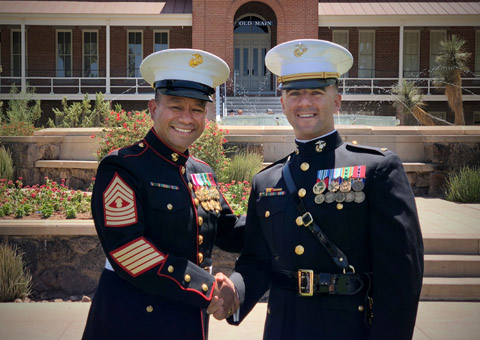 Newly-commissioned 2nd Lt. Brian A. Tuthill shakes hands with Master Gunnery Sgt. Demetrio Espinosa after Espinosa rendered Tuthill’s first salute on stage during the University of Arizona’s May 12 commissioning ceremony.  Espinosa first served with Tuthill in 2008 as his public affairs chief at Marine Corps Base Hawaii, and he travelled from Camp Pendleton to be part of the ceremony in Tucson. (Photo by Midn. 2nd Class Emilio Mackie)